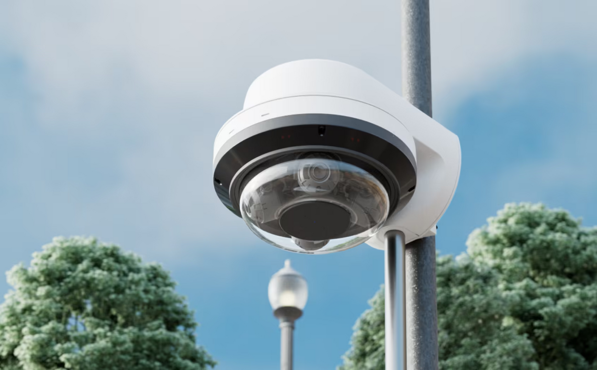 Ubiquiti UACC-AI-MS-4-AM-W UniFi AI Multi Sensor 4 white camera arm mount fitted to an outdoor pole with a camera and cable conduit.