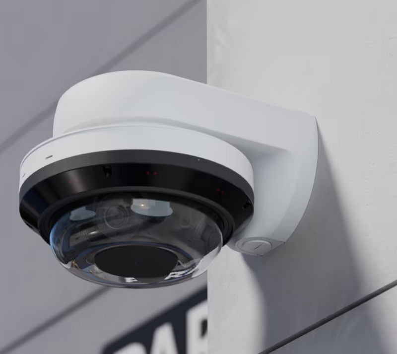 Ubiquiti UACC-AI-MS-4-AM-W UniFi AI Multi Sensor 4 white camera arm mount secured to an exterior wall with a dome camera, viewed from below.