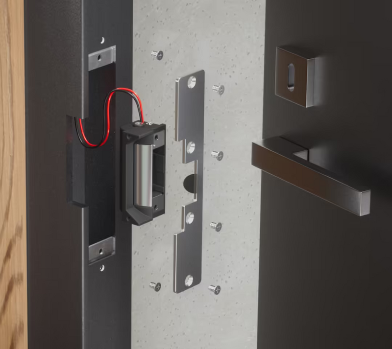 Ubiquiti UACC-Lock-Strike-Safe-15mm UniFi Standard 15mm Fail-Safe Strike Lock installed with a long faceplate in a metal door frame beside an open door