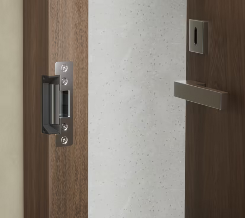 Ubiquiti UACC-Lock-Strike-Secure-15mm UniFi Standard Fail-Secure Strike Lock installed with the short front plate in a timber door frame.