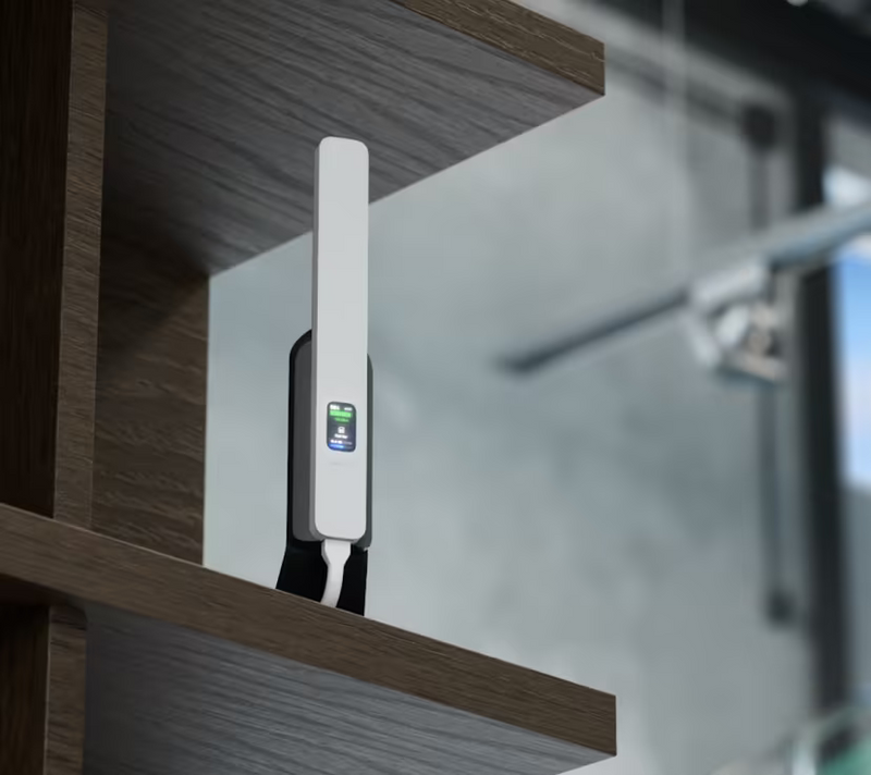 Ubiquiti U5G UniFi 5G Backup on a wooden shelf with desktop stand and illuminated status display
