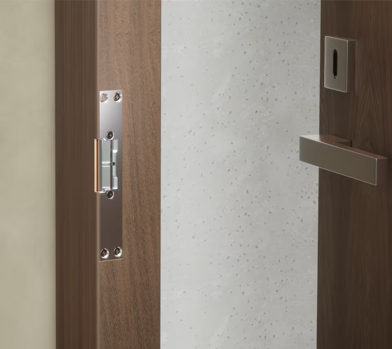 Ubiquiti UACC-Lock-Strike-Secure-8mm UniFi Narrow 8mm Fail-Secure Strike Lock installed with the short front plate in a timber door frame.
