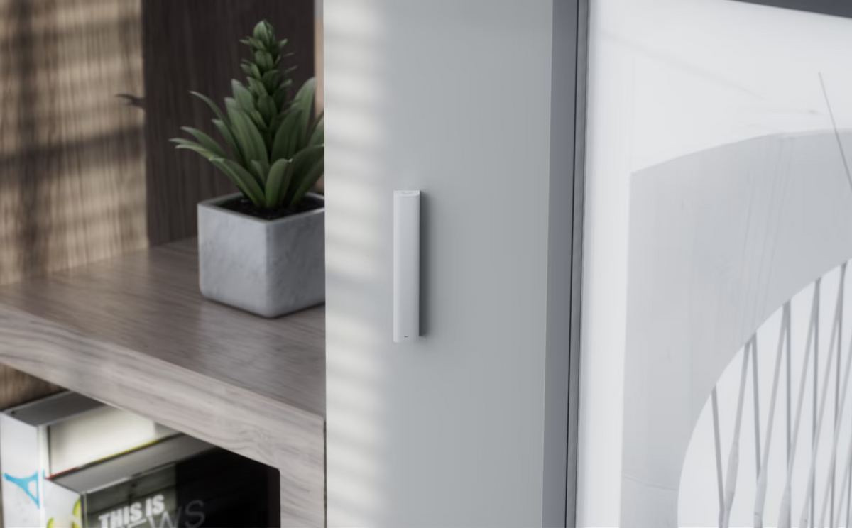 Ubiquiti USL-GlassBreak security sensor discreetly installed beside a large glass window