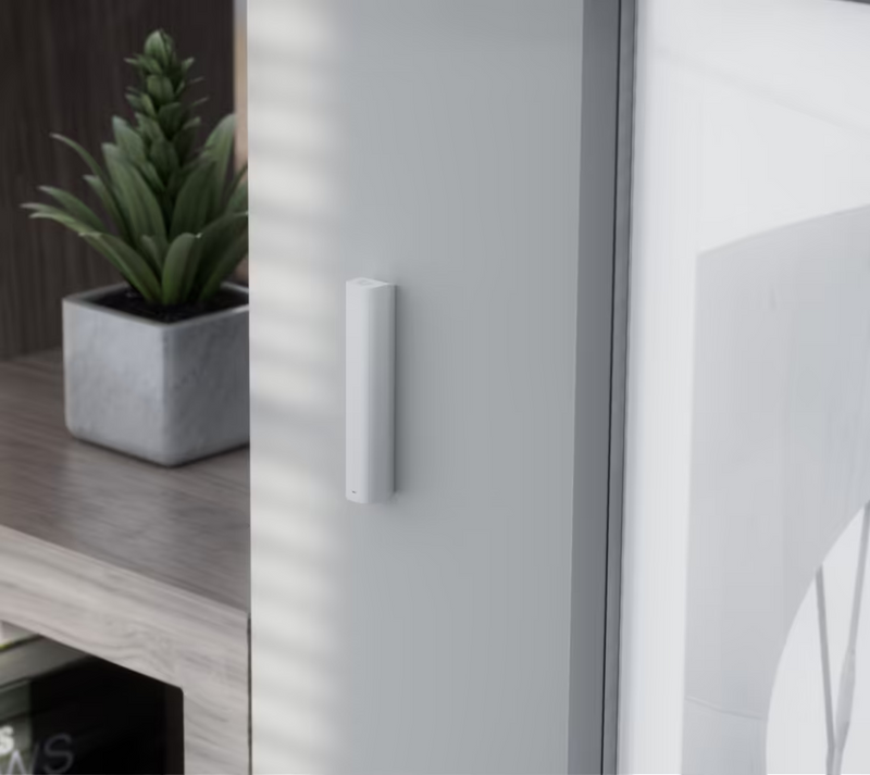 Side view of the slim Ubiquiti UniFi Glass Break Sensor mounted near a window