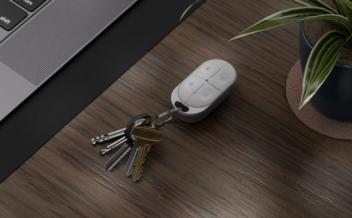 Ubiquiti USL-FOB UniFi Remote Control KeyFob attached to keys on a desk, showing four security control buttons
