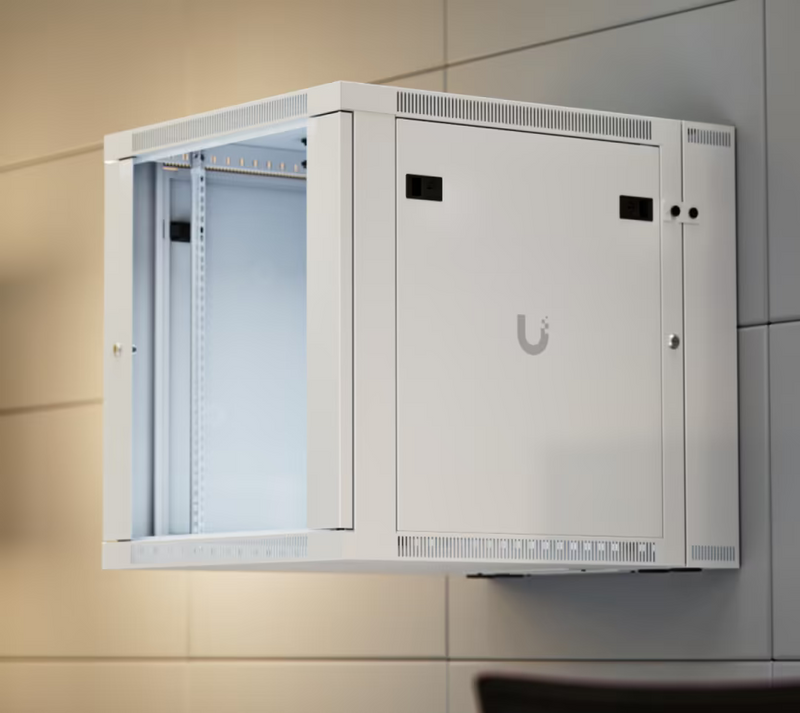 Ubiquiti UACC-Rack-12U-Wall-SW-G UniFi Swing 12U Rack Cabinet installed on a panelled wall, showing the tempered glass front door, internal rails and vented side panel.