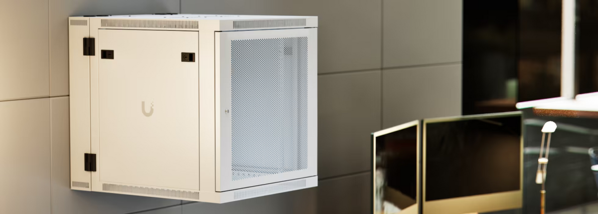 Ubiquiti UACC-Rack-12U-Wall-SW-P UniFi Swing 12U Rack Cabinet wall-mounted in an office with perforated front door and lockable side panel