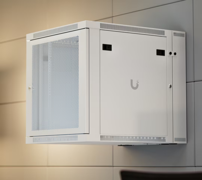 Ubiquiti UACC-Rack-12U-Wall-SW-P UniFi Swing 12U Rack Cabinet installed on a wall with perforated front door and ventilated enclosure