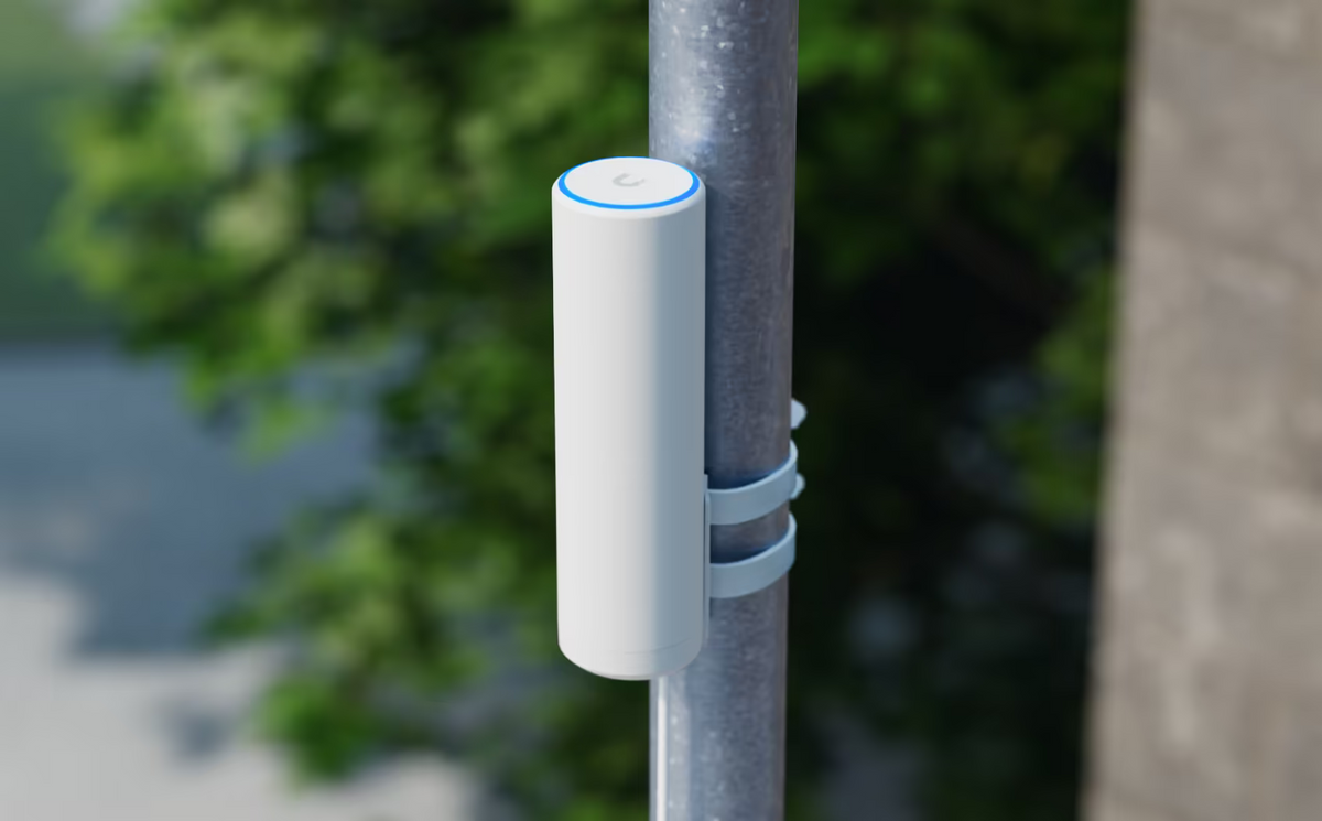 Ubiquiti U7-Mesh UniFi U7 Mesh WiFi access point secured to an outdoor pole with two straps and an illuminated LED ring.