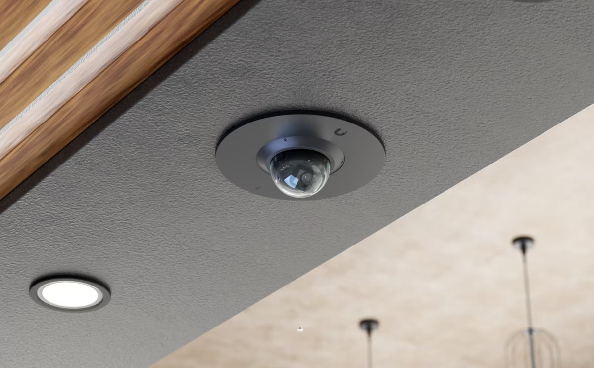 Ubiquiti UACC-G6-Dome-FM black flush mount installed in a grey ceiling with a UniFi G6 Dome camera.