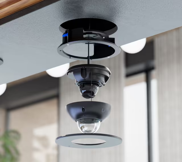 Exploded ceiling installation view of the Ubiquiti UACC-G6-Dome-FM, showing the housing, camera, dome cover and trim ring.