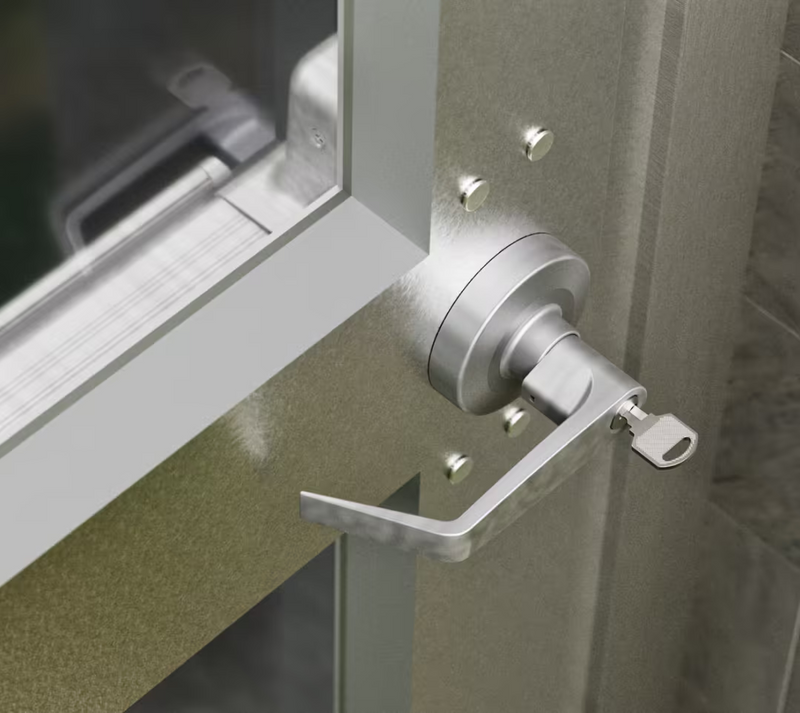 Ubiquiti UACC-PanicBar UniFi Panic Bar exterior keyed lever handle installed on a framed glass door with the key inserted.