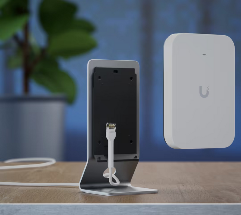Ubiquiti UniFi U7 Pro XG Wall shown detached from the table stand with Ethernet cable connected to the mounting plate