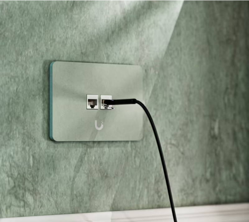 Ubiquiti UniFi horizontal two-port paintable keystone wall plate with an Ethernet cable connected