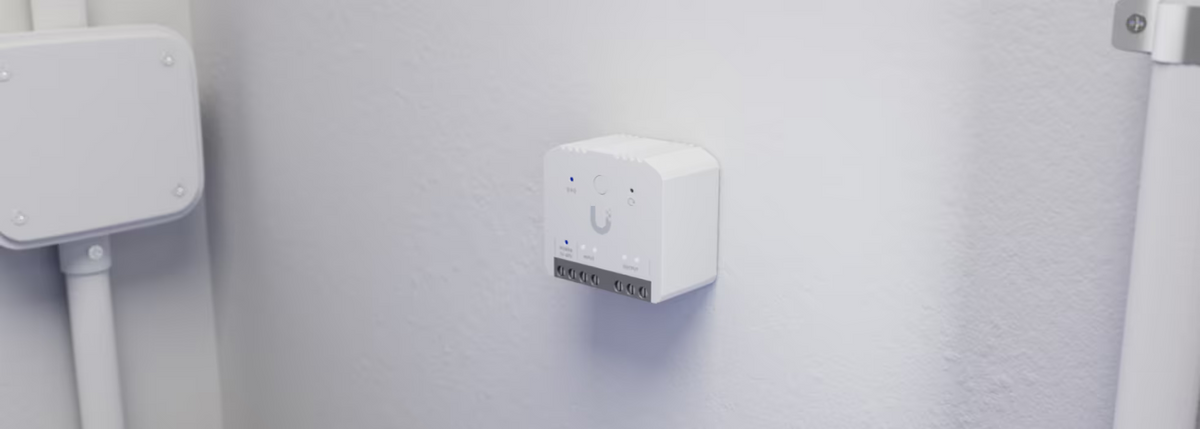 Ubiquiti USL-Relay UniFi Relay installed on a wall with status LEDs and wiring terminals visible