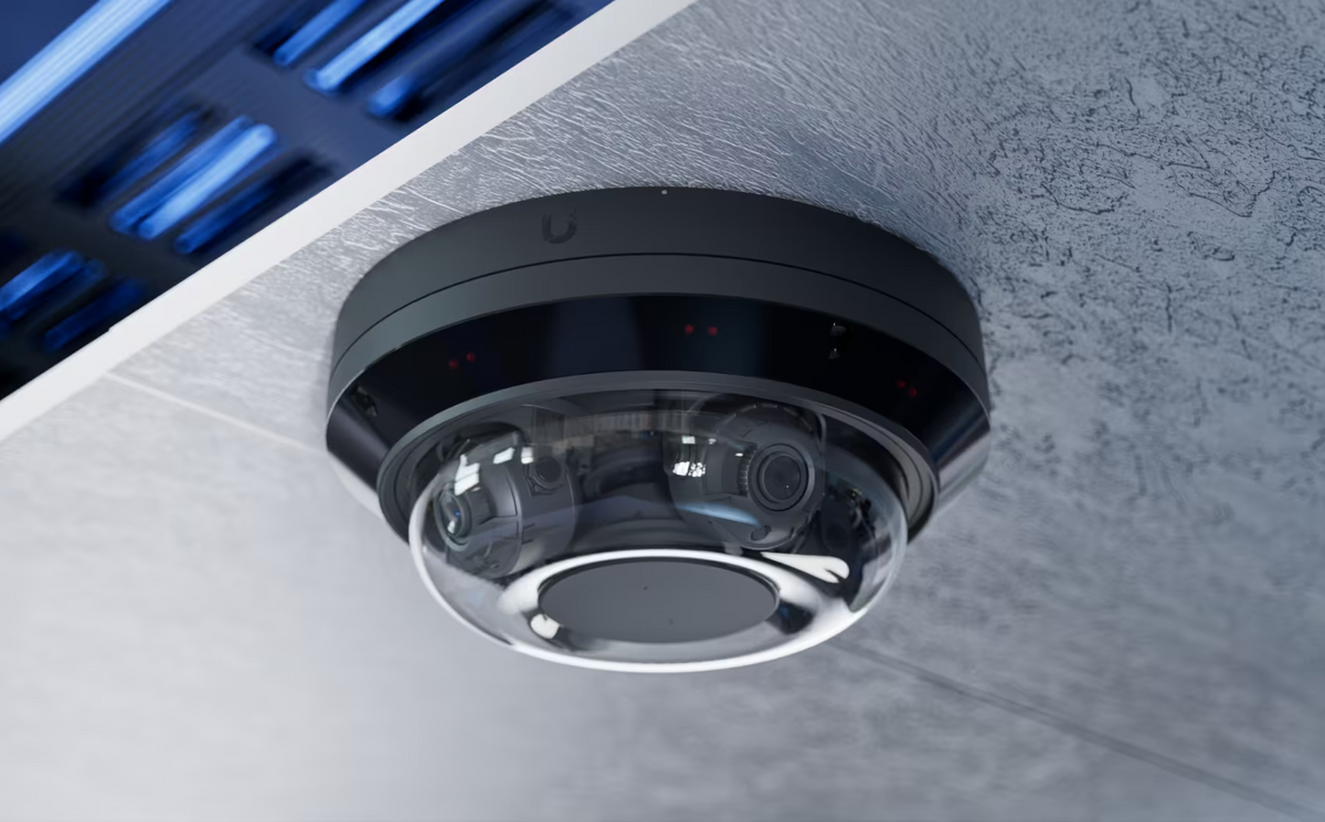 Ceiling-mounted Ubiquiti UniFi AI Multi Sensor 4 Black showing multiple lenses inside its clear dome