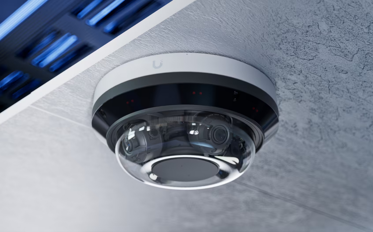 Ubiquiti UniFi AI Multi Sensor 4 White installed on a concrete ceiling with four lenses under the clear dome